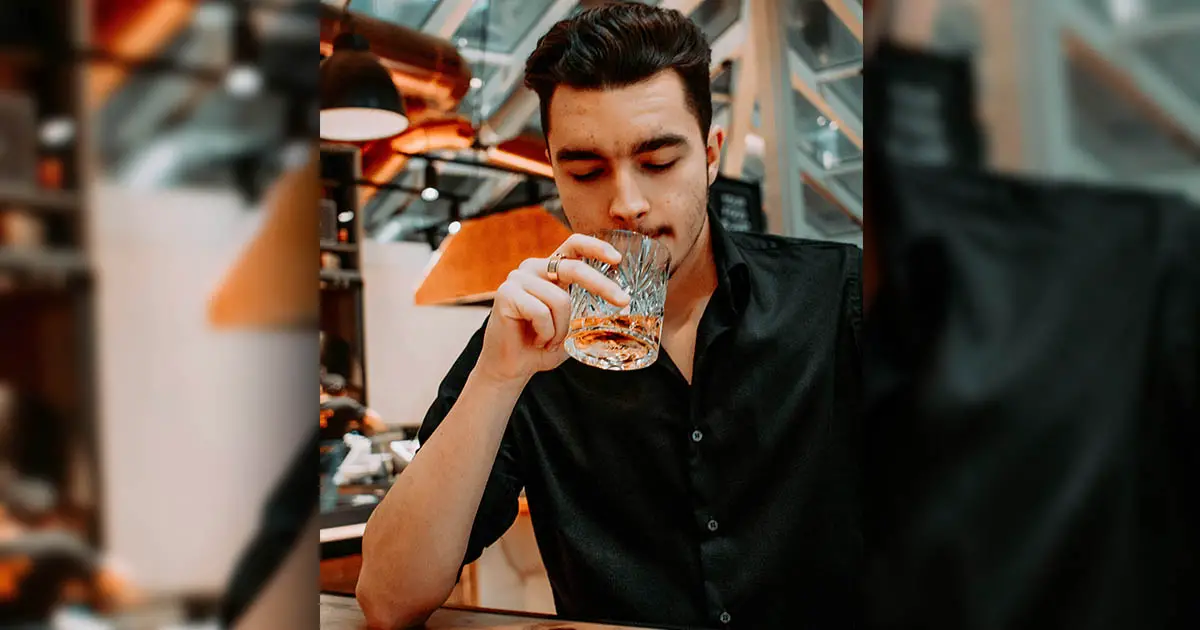a picture of a man who drinking something