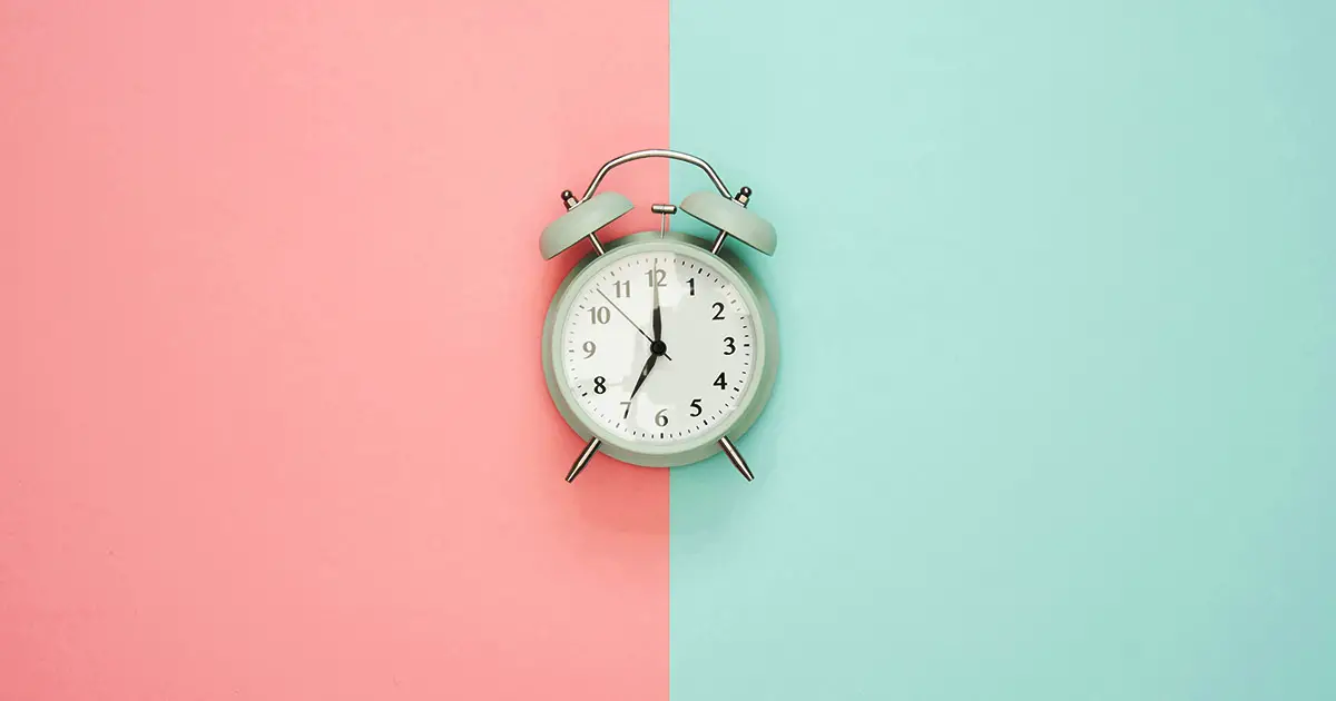 a clock with pink cream background